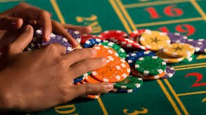 qt777 login PMGC dealer managing a live multi-player blackjack round in studio